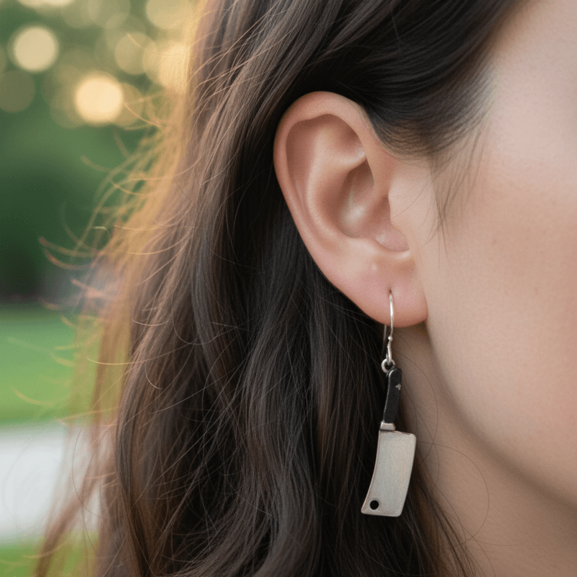 woman wearing edgy silver cleaver earrings