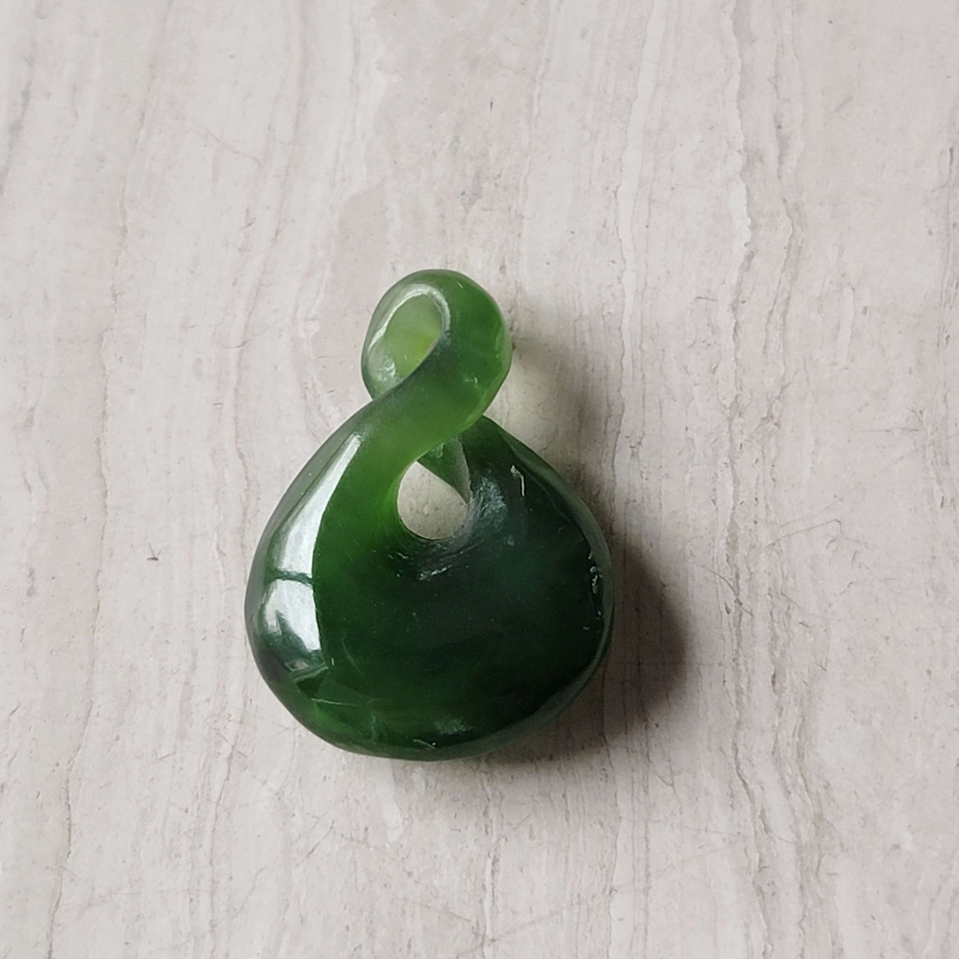 Jade infinity charm