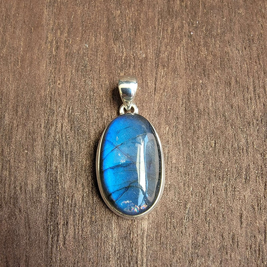 oval labradorite pendant set in silver with blue flash