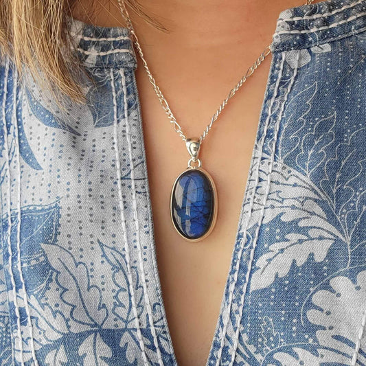 oval labradorite pendant set in silver with blue flash