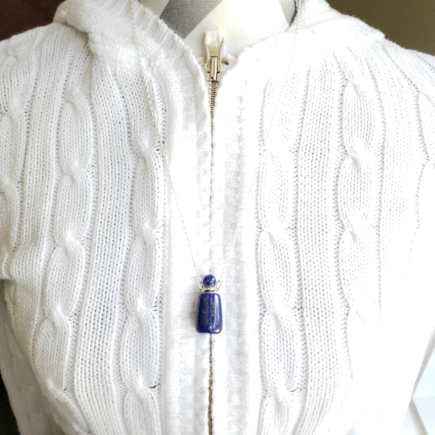 A lapis lazuli bottle pendant necklace with a silver-colored cap and a chain