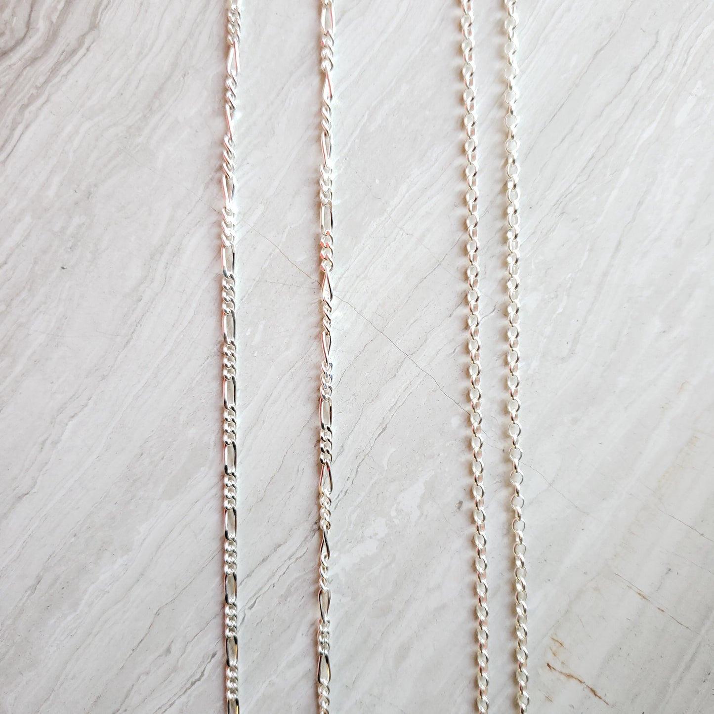 silver figaro and rolo chains