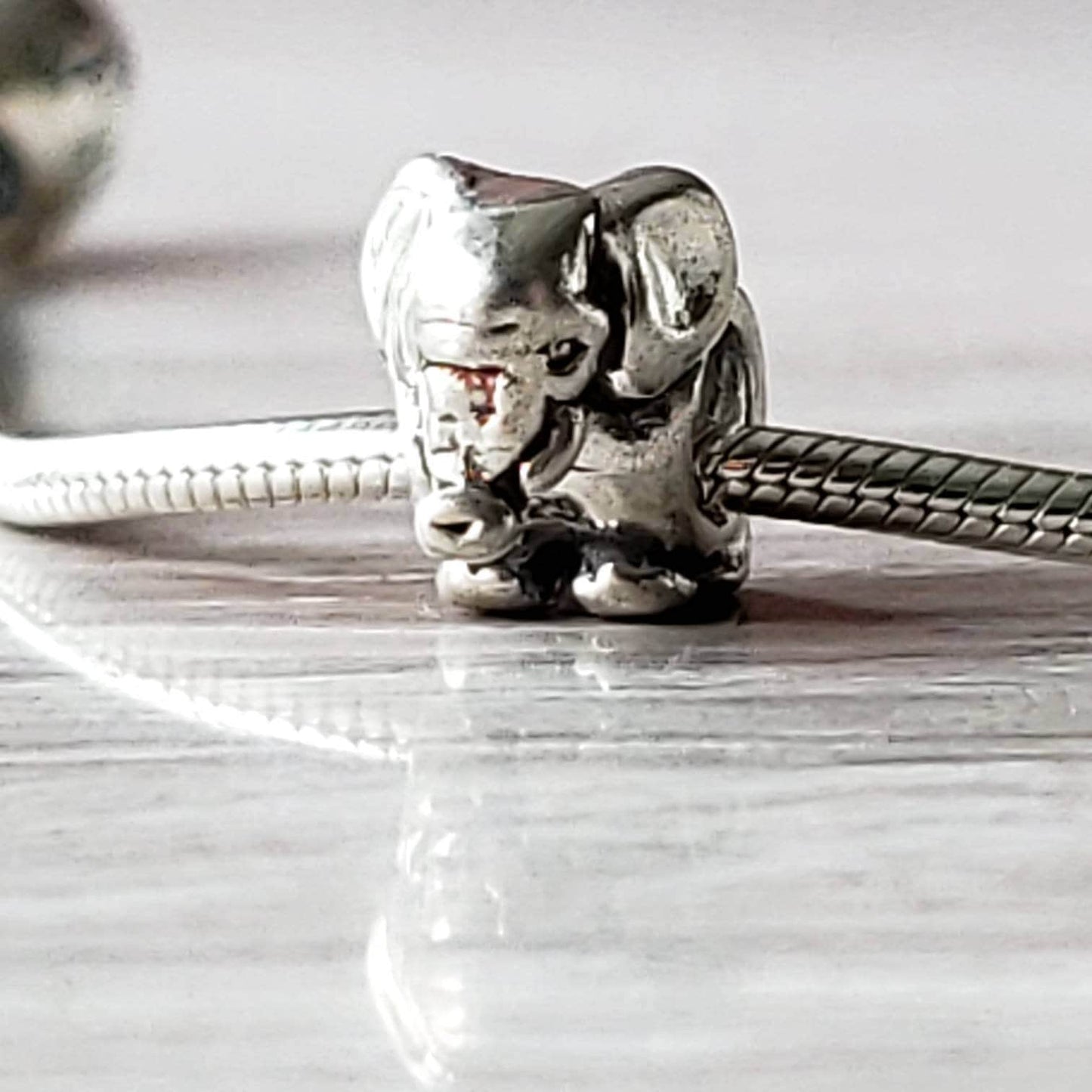 A 925 silver elephant charm spacer bead with a detailed design, intended for use in bracelet making.