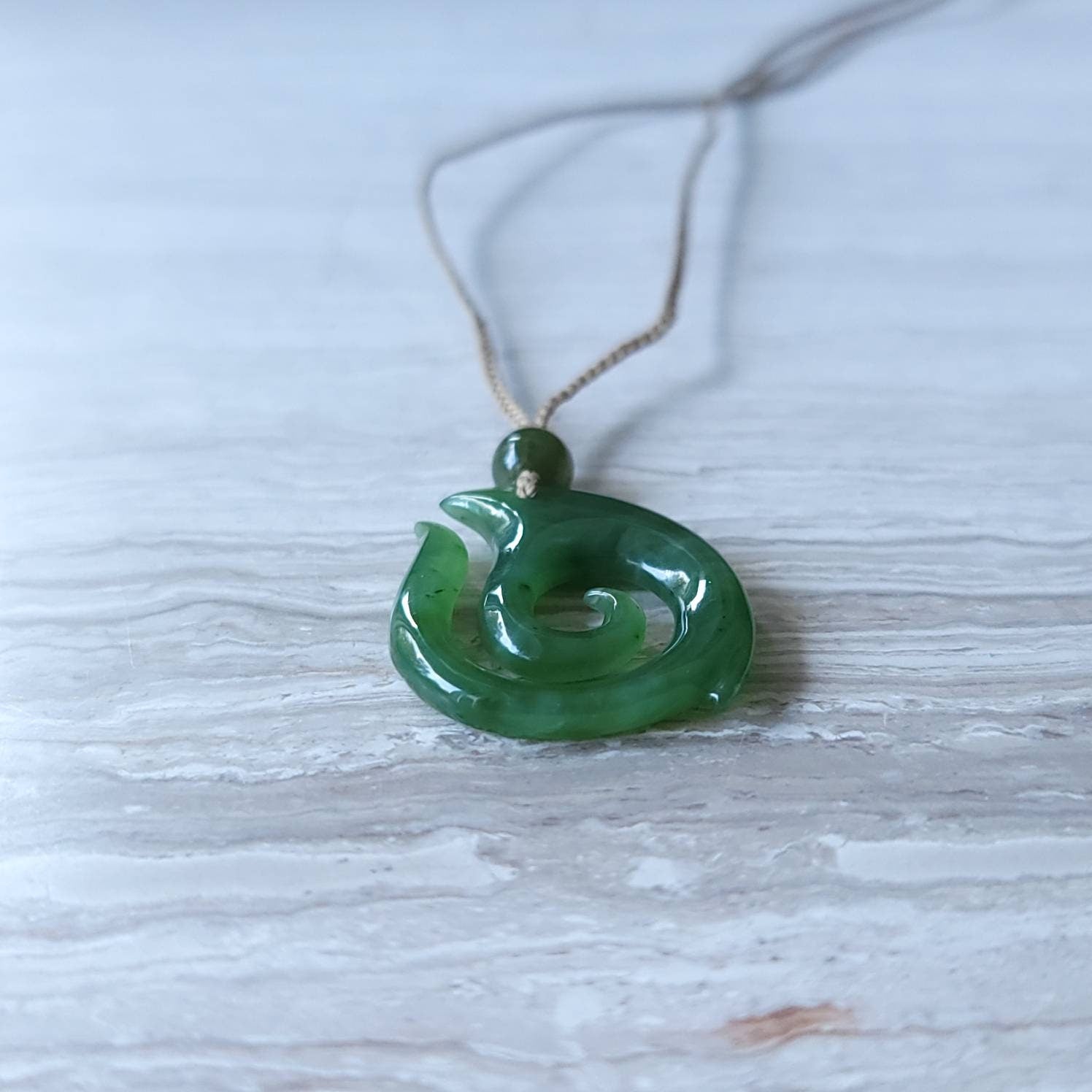 jade maori fish hook necklace