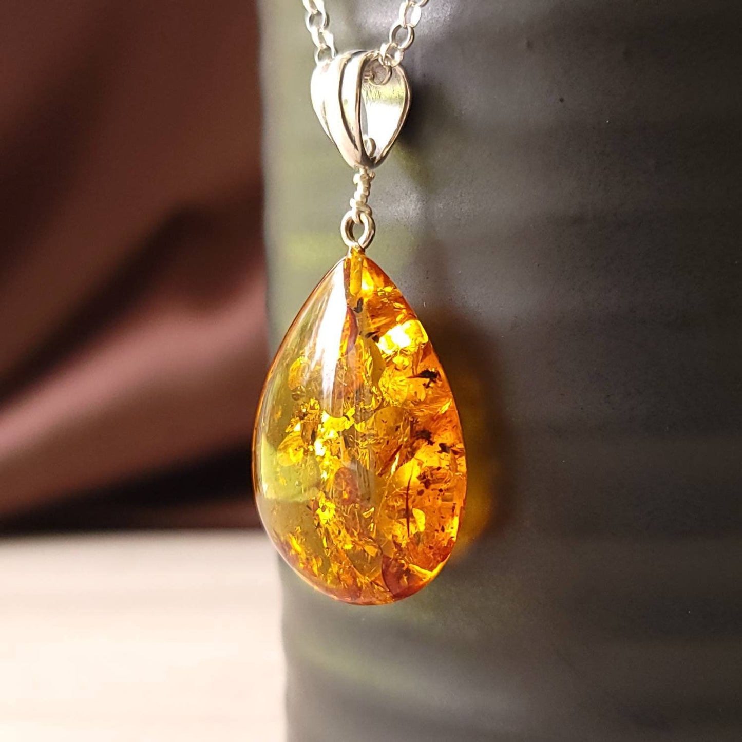 teardrop amber pendant with a silver bail.