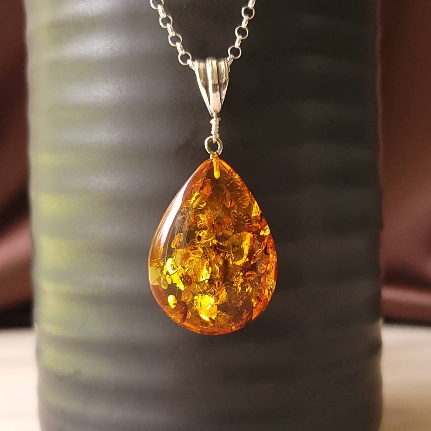 teardrop amber pendant with a silver bail.