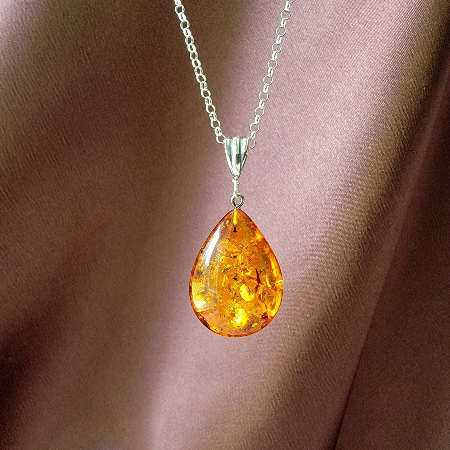 teardrop amber pendant with a silver bail.