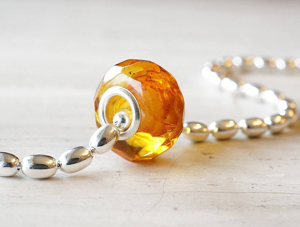 sterling silver heavy rice bead chain with a honey colored amber bead