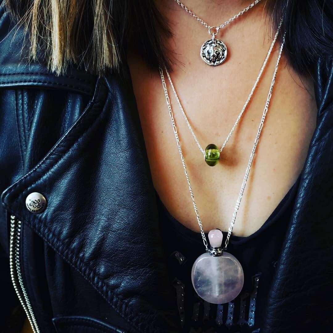 layered silver necklaces with gemstone pedants and beads