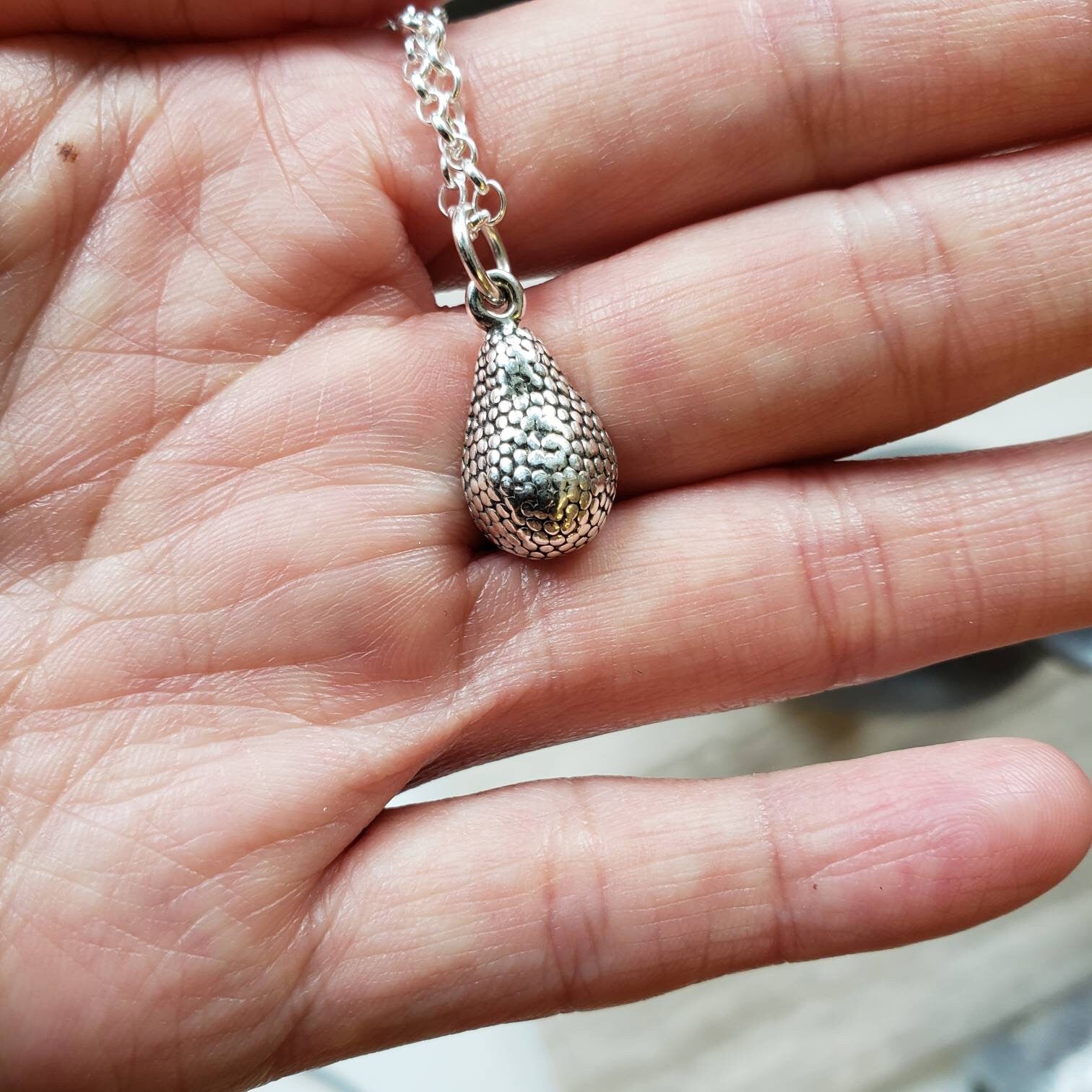 silver and gold avocado charm pendant