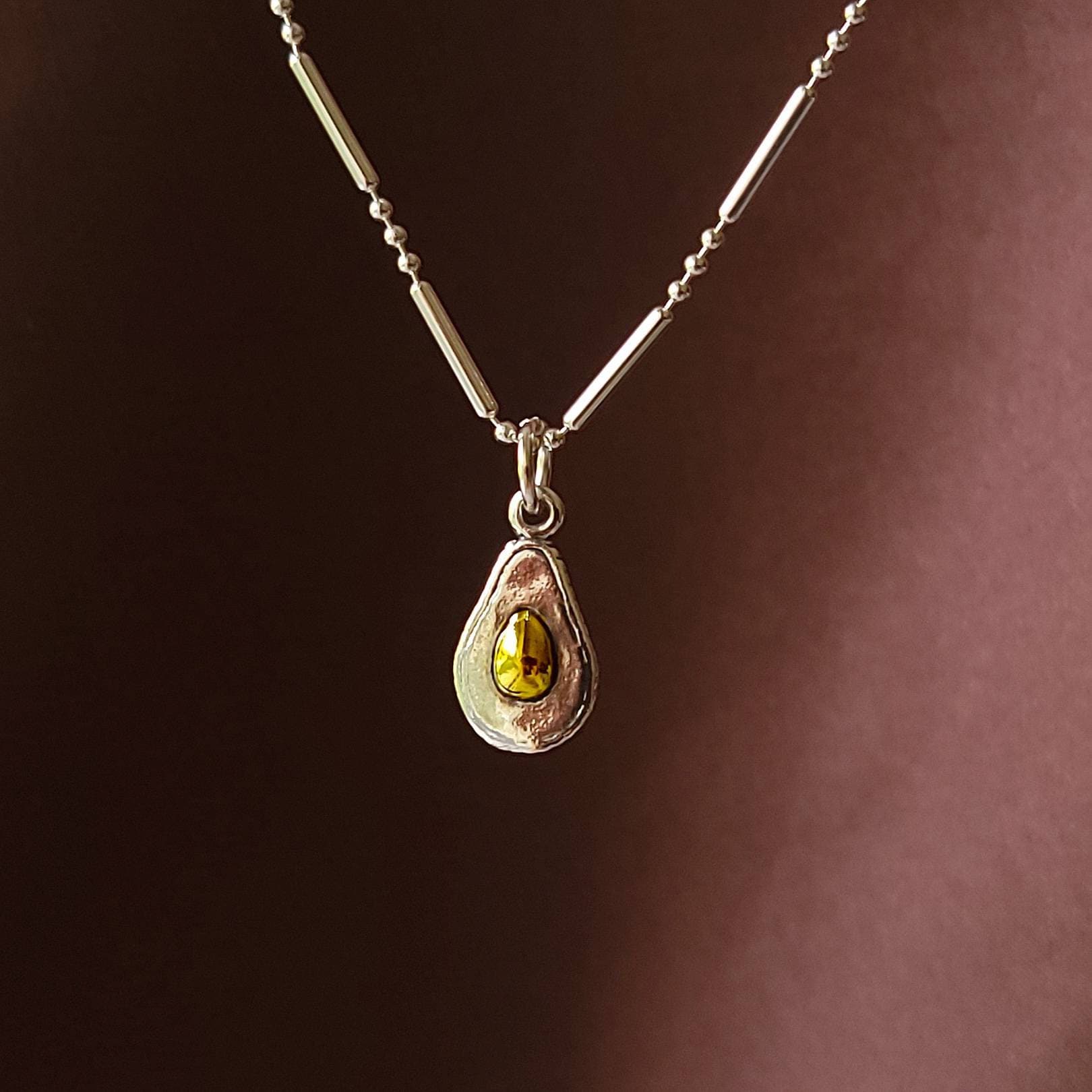 silver and gold avocado charm pendant