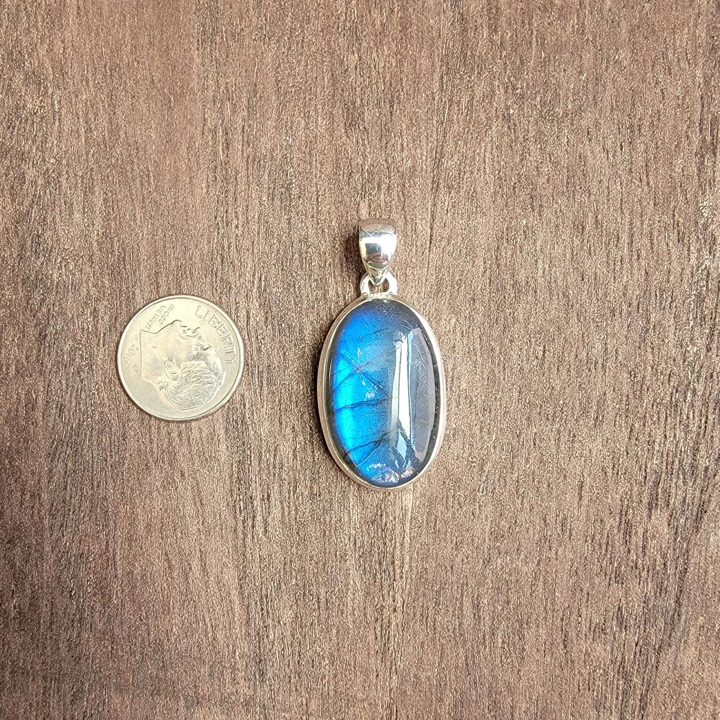 oval labradorite pendant set in silver with blue flash