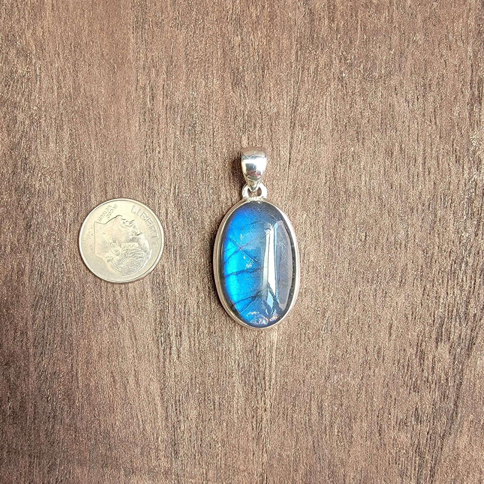 oval labradorite pendant set in silver with blue flash