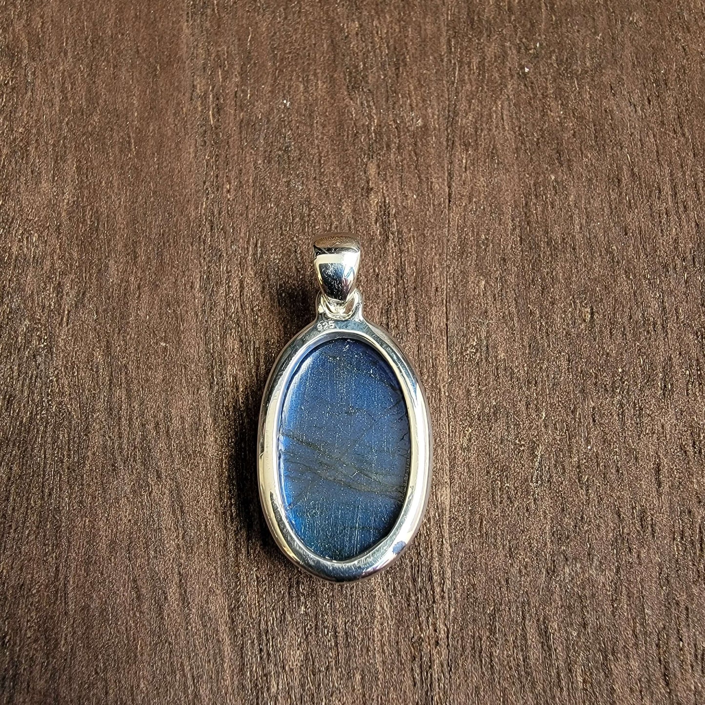 oval labradorite pendant set in silver with blue flash, reverse