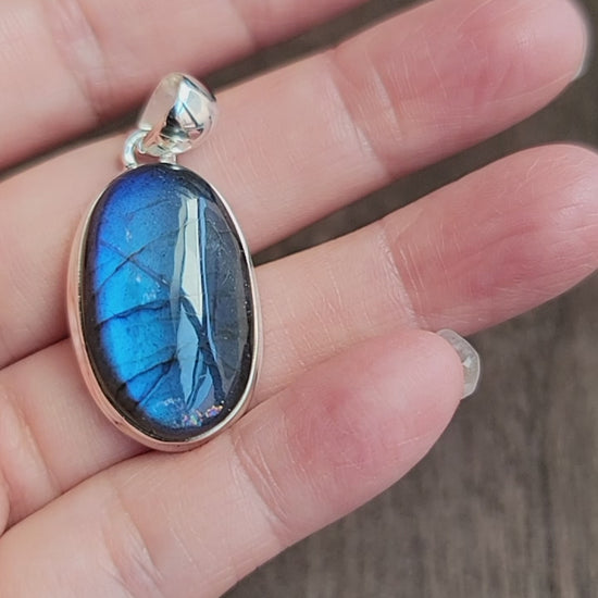 oval labradorite pendant set in silver with blue flash