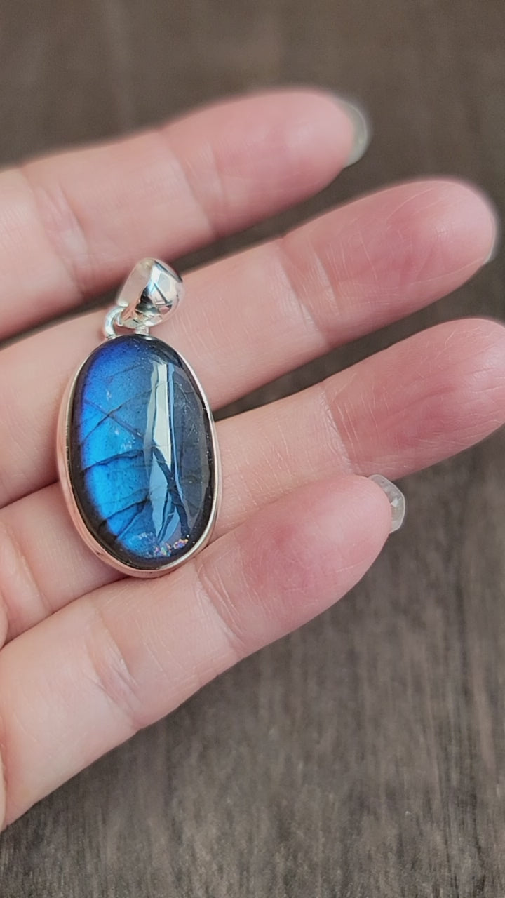 oval labradorite pendant set in silver with blue flash