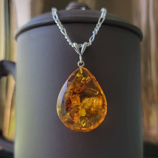 teardrop amber pendant with a silver bail.